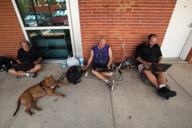 Bitcoin Homeless Paul Harrison, Chris Kantola, and Jesse Angle, scrounging for bitcoins outside a public library in Pensacola, Florida. Photo: Michael Spooneybarger/WIRED